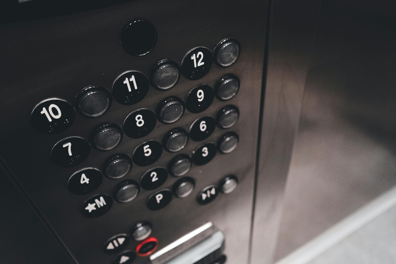 Home Detail view of a sleek elevator control panel with metallic finish and numbered buttons.